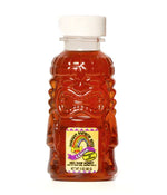 3oz tiki bottle of lehua organic honey made in Hawaii. Rainbow Bees.